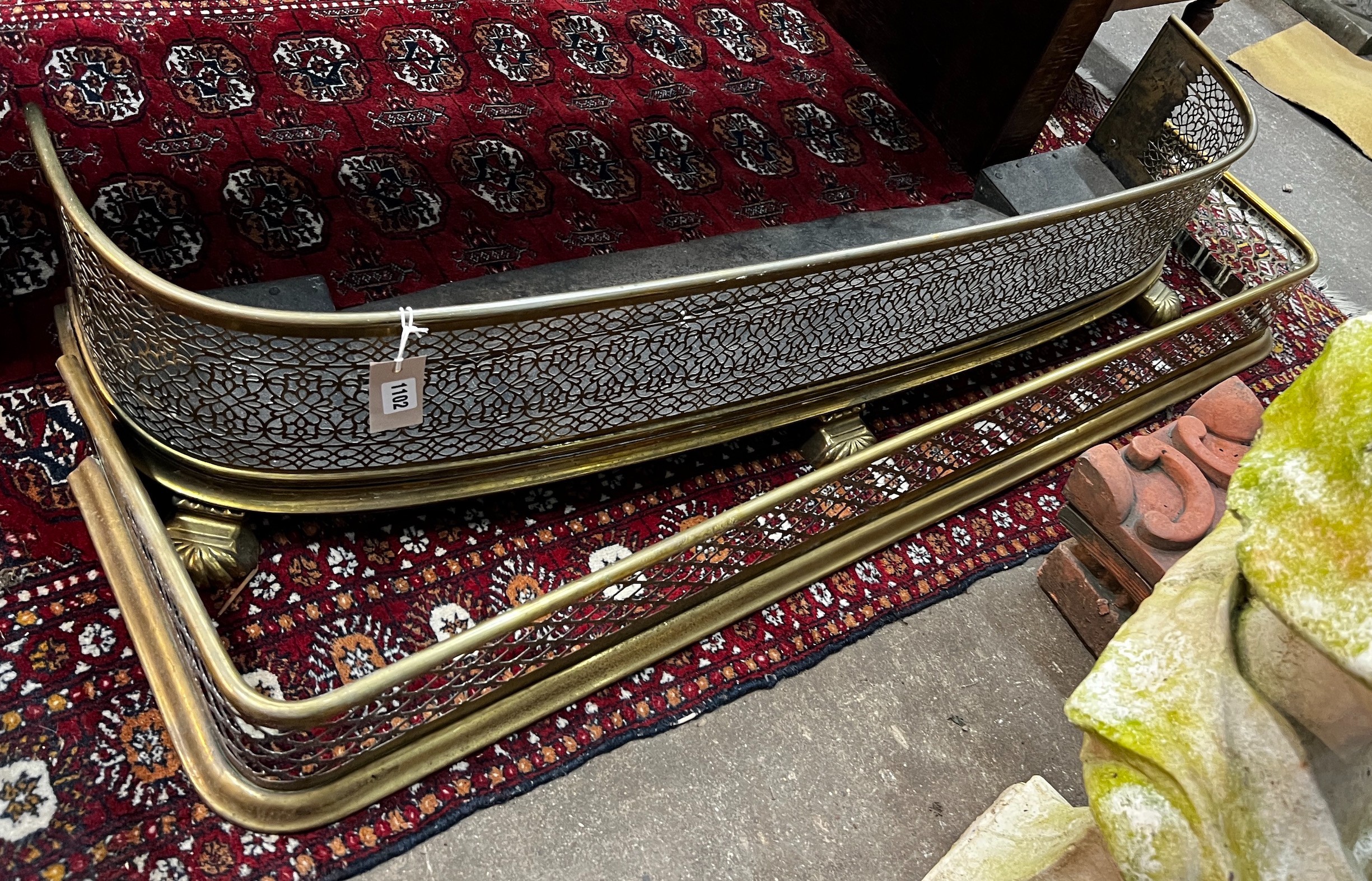 Two Victorian pierced brass fenders, larger width 123cm